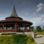 Serene lake with colorful boats.
