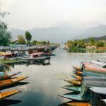 Serene lake with colorful boats.
