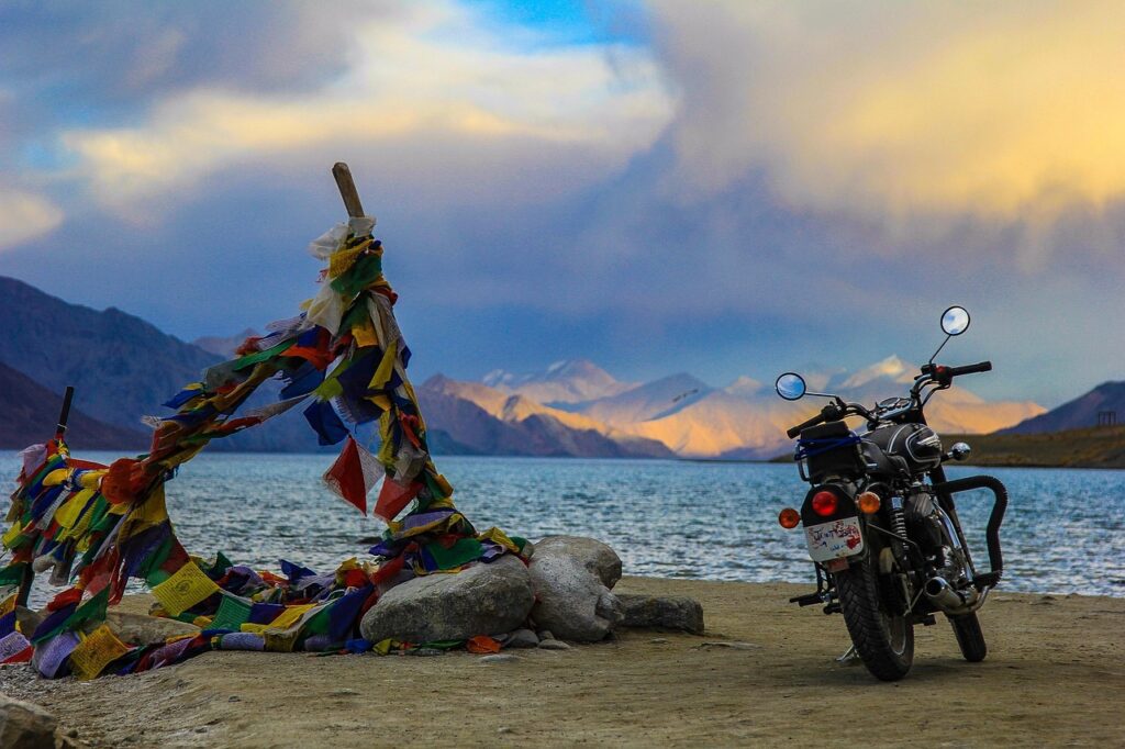 Motorcycle by lake with prayer flags